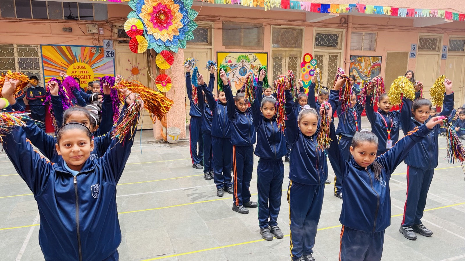Students celebrating Sports Week with colourful pom-poms