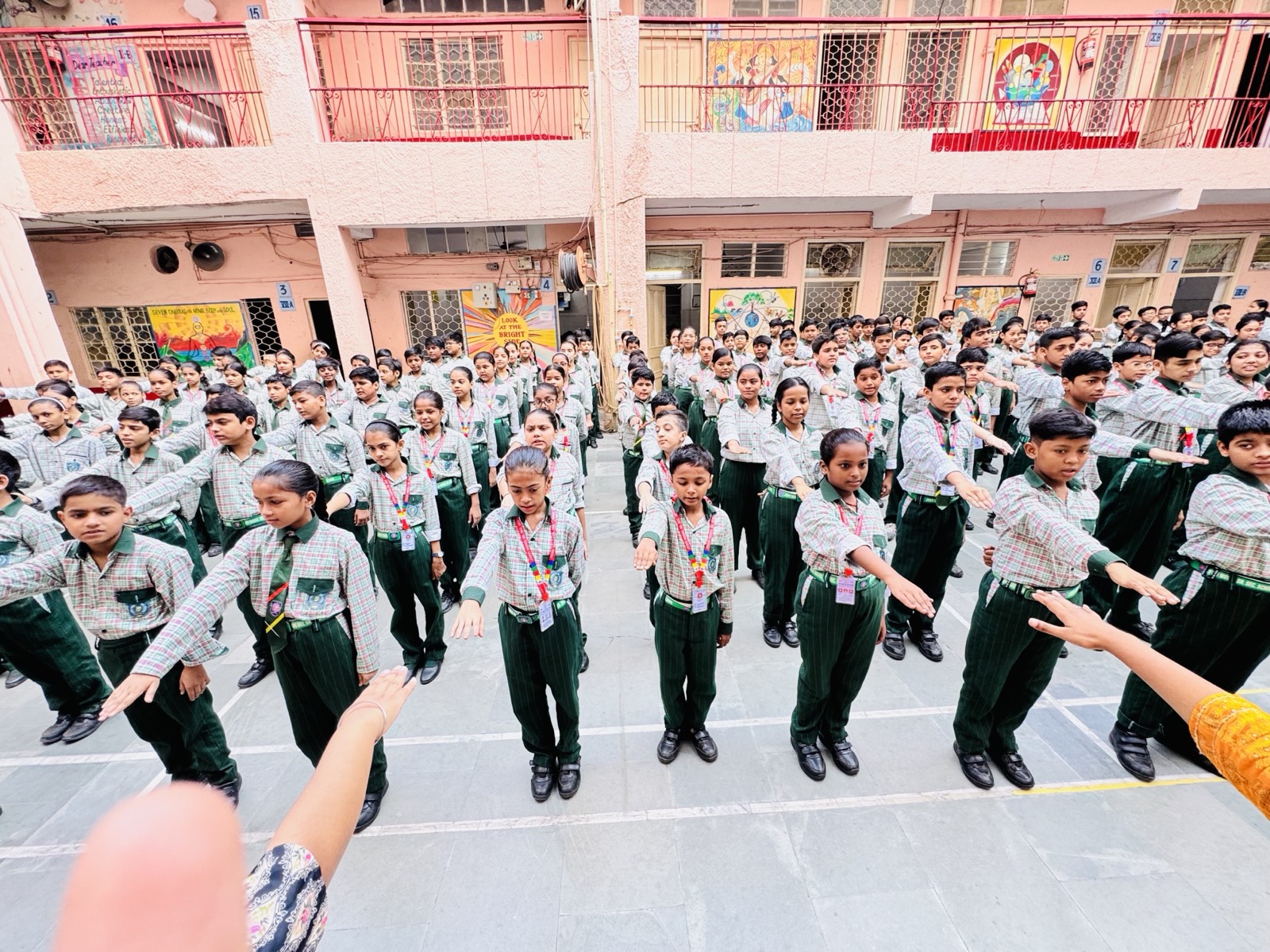 Morning assembly — students in rows across the school courtyard